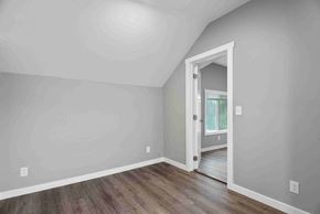 Tacoma apartment for rent - a room with white walls and wooden floors and a door to a hallway