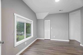 Tacoma apartment for rent - an empty living room with a large window and wooden floors