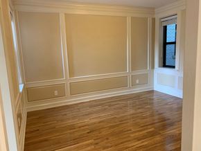 Saint Louis apartment for rent - a living room with wooden floors and tan walls and a window