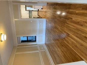 Saint Louis apartment for rent - the view from the top of a staircase looking down into a room with wood floor