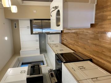 Saint Louis apartment for rent - a kitchen with white cabinets and a wood floor