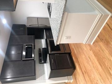 Saint Louis apartment for rent - A kitchen with black appliances and a wooden floor.