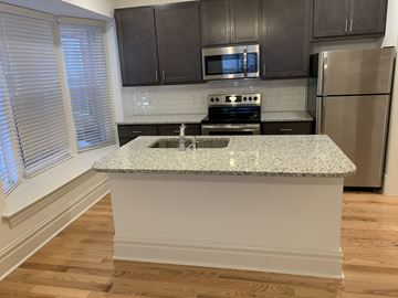 Saint Louis apartment for rent - A kitchen with a granite countertop and stainless steel appliances.
