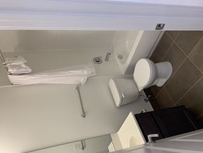 Saint Louis apartment for rent - A white toilet is in a bathroom with a white tub.
