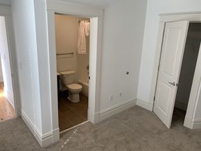 Saint Louis apartment for rent - A bathroom with a toilet and a towel hanging on the door.