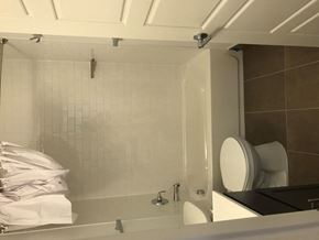 Saint Louis apartment for rent - A bathroom with a toilet, sink, and shower.