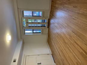 Saint Louis apartment for rent - A wooden floor leads to a white door.