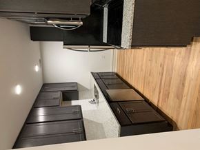 Saint Louis apartment for rent - A kitchen with black appliances and wooden walls.