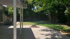 West Hills apartment for rent - A patio with a fire pit and trees in the background.