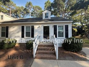 Wilson apartment for rent - A white house with black shutters and a sign that says J.W. Hunter Company Inc.