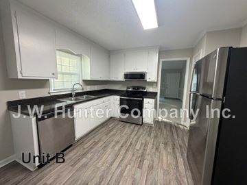 Wilson apartment for rent - A kitchen with white cabinets and a black fridge is labeled Unit B.