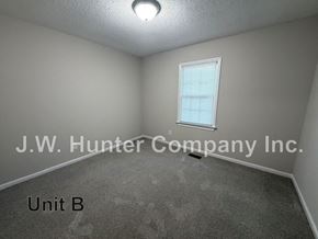 Wilson apartment for rent - A room with a window and carpeted floor.