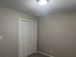 Wilson apartment for rent - A white closet door is in a room with a light on the ceiling.
