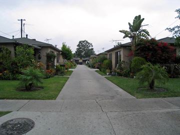 Bell apartment for rent - A residential street with houses on both sides and a sidewalk in the middle.