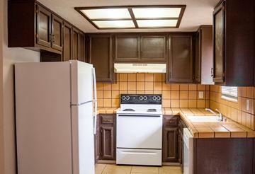 Merced house for rent - a kitchen with a white stove and a refrigerator