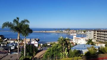 Corona Del Mar apartment for rent - A view of a coastal town with buildings and a body of water.