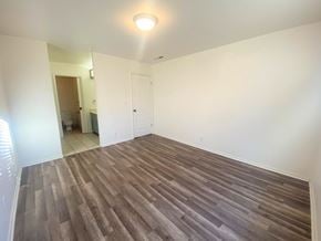 Merced house for rent - A room with a wooden floor and white walls.