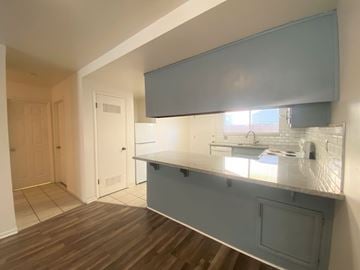 Merced house for rent - A kitchen area with a counter and a window.
