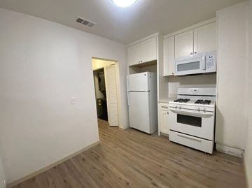 Merced house for rent - a kitchen with white appliances and a white refrigerator