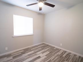 Merced house for rent - A room with a ceiling fan and a window.