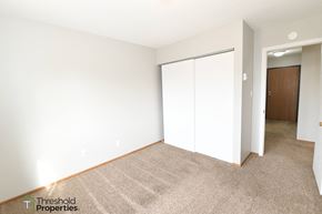 Grand Forks apartment for rent - a bedroom with white walls and carpet and a closet