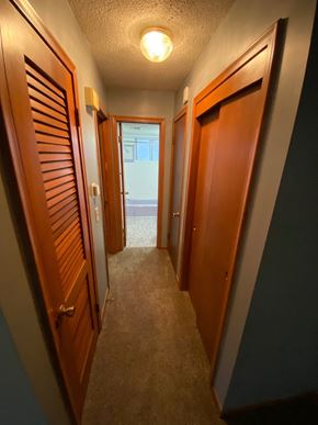Omaha apartment for rent - a hallway with wooden doors and a view of the ocean