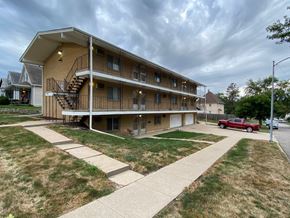 Omaha apartment for rent - an apartment building with a red truck parked in front of it