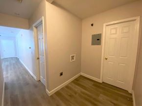 Merced house for rent - A hallway with two doors and a light switch on the wall.