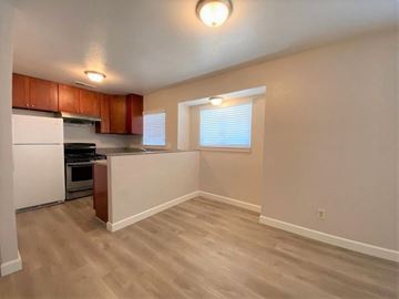 Merced house for rent - A kitchen with wooden cabinets and a white refrigerator.