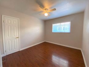 Merced house for rent - A room with a ceiling fan and a window with blinds.
