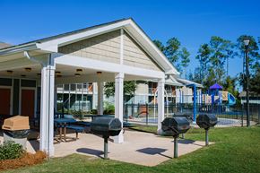 St. Mary's apartment for rent - a clubhouse with a patio and grill in front of a house