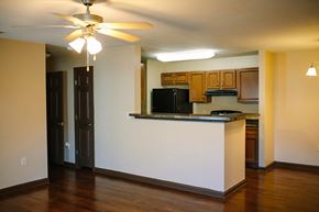 St. Mary's apartment for rent - an empty living room with a kitchen and a ceiling fan
