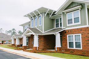 Thomasville apartment for rent - a row of homes with white columns and green roofs
