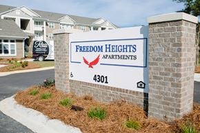 Valdosta apartment for rent - a sign for freedom heights apartments in front of a building