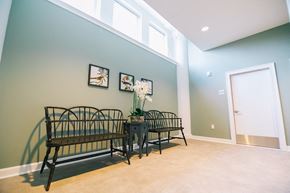 Pelham apartment for rent - a dining room with two benches and a table with flowers