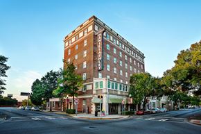 Valdosta apartment for rent - a tall brick building on the corner of a city street