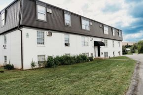 Lexington apartment for rent - a large white building with a black roof and a lawn