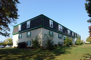 Lexington apartment for rent - a large white house with a green roof on a lawn