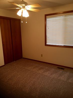 Tigard house for rent - an empty room with a ceiling fan and a window