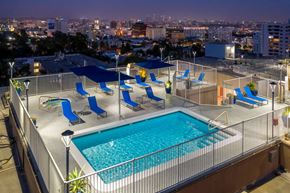 Hollywood apartment for rent - a pool on the rooftop of a hotel overlooking a city at night