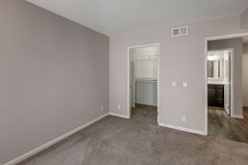 Hollywood apartment for rent - a living room with carpet and a door to a bathroom
