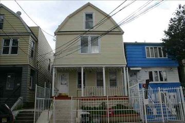 Jersey City apartment for rent - A house with a white porch and a red railing.