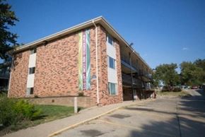 Omaha apartment for rent - a brick building with banners on the side of it