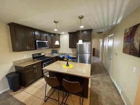 Omaha apartment for rent - full kitchen with granite countertops and stainless steel appliances and a breakfast bar