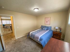 Omaha apartment for rent - a bedroom with a bed and a door to a living room