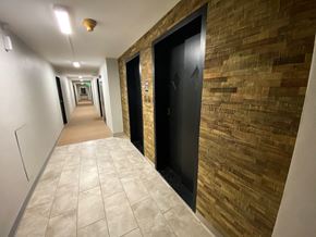 Omaha apartment for rent - a hallway of elevators and doors in a building