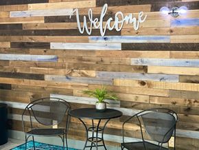 Omaha apartment for rent - a table and chairs in front of a wooden wall
