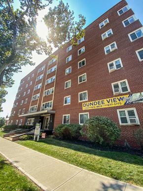 Omaha apartment for rent - a brick building with a yellow sign in front of it