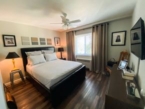 Omaha apartment for rent - the master bedroom has a large bed and a large window
