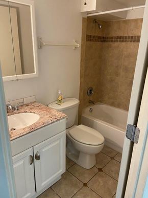 Richland apartment for rent - A bathroom with a toilet, sink, and bathtub.